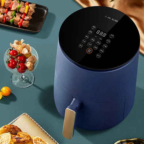 Blue air fryer on green table