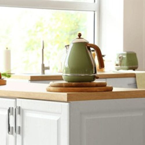 Electric kettle on wooden countertop in modern kitchen