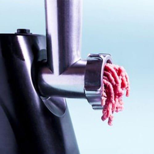 Kitchen appliance electric meat grinder on a light background. Me